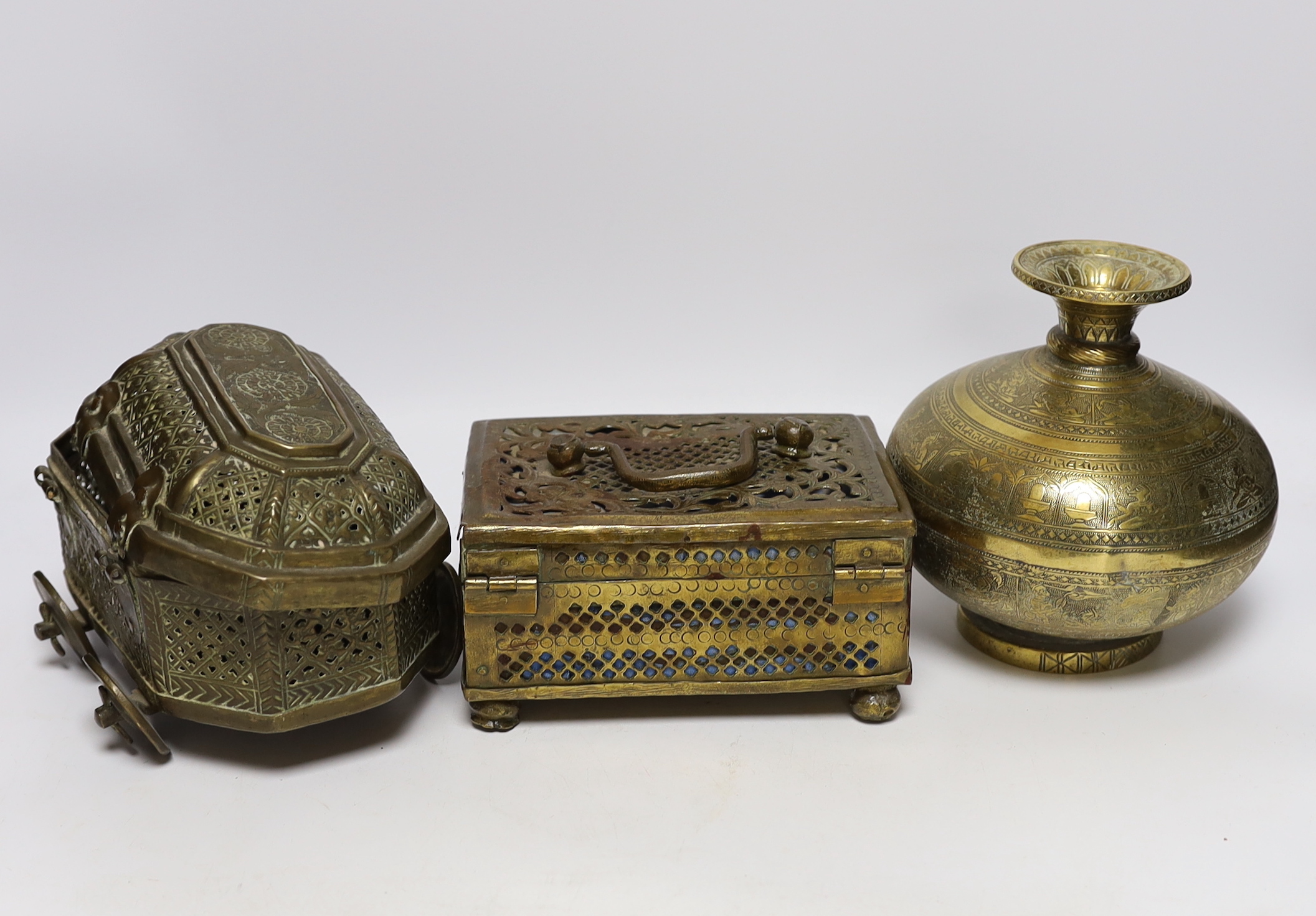 Eastern brassware to include a betel box on wheels, a vase with engraved detail and a pierced box, tallest 15.5cm (3)